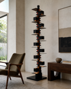 The Skyscraper Floor Lamp by The Qratist features a sculptural black stainless steel structure with stacked geometric forms and concealed warm illumination inspired by the silhouette of a modern city skyline.