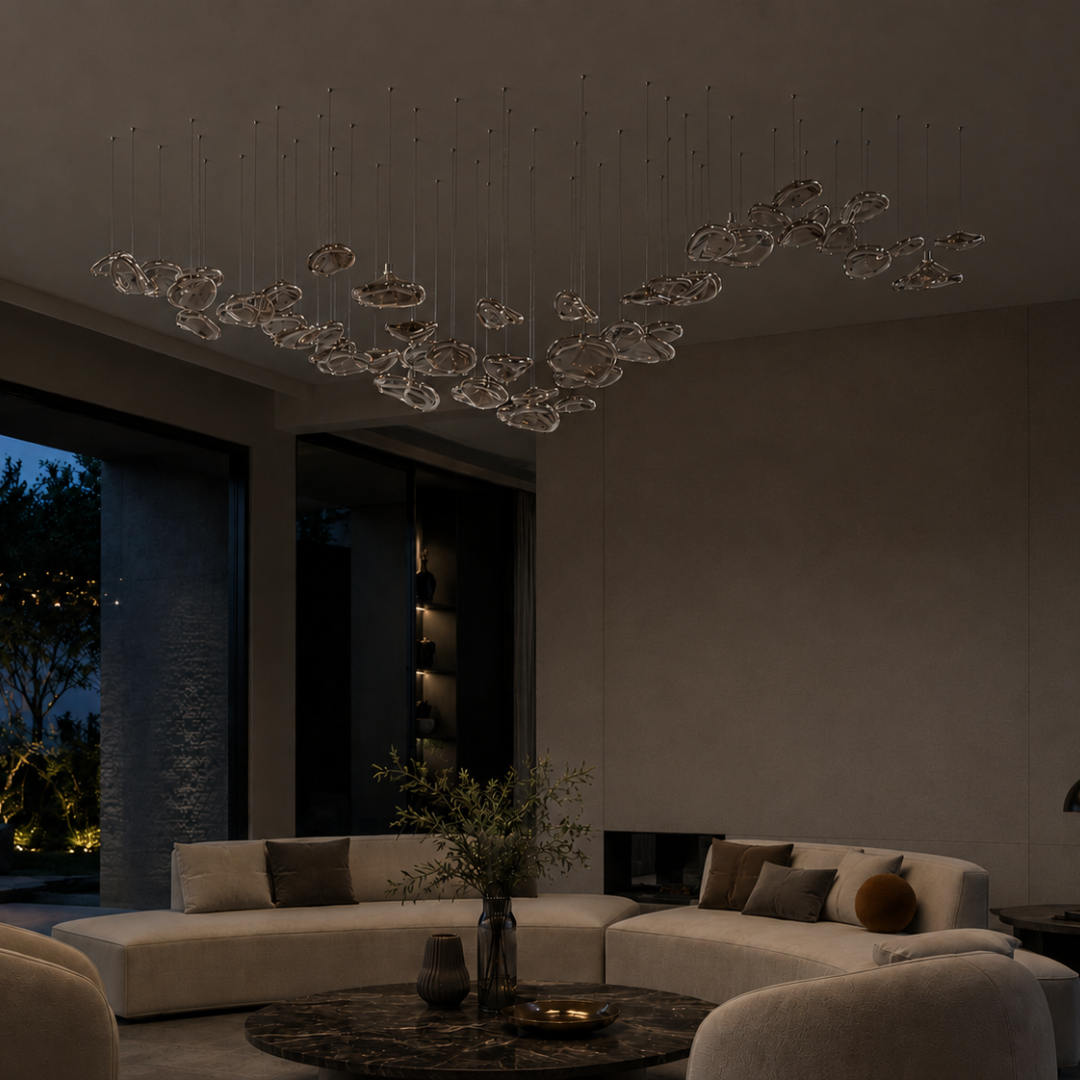 The Veil chandelier by the Qratist features suspended rose gold glass elements in a flowing sculptural arrangement. 