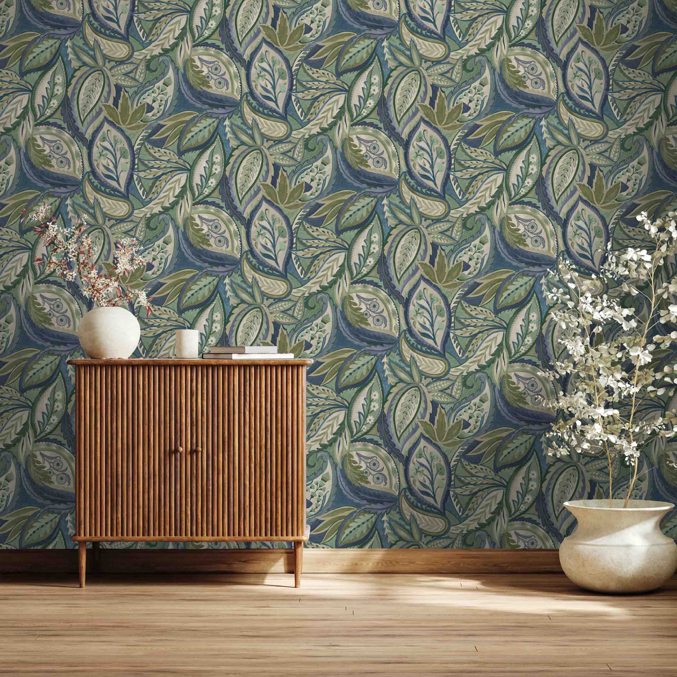 Zephyra floral non-woven wallpaper displayed in a modern room interior with botanical patterns in blue, green, and yellow hues.