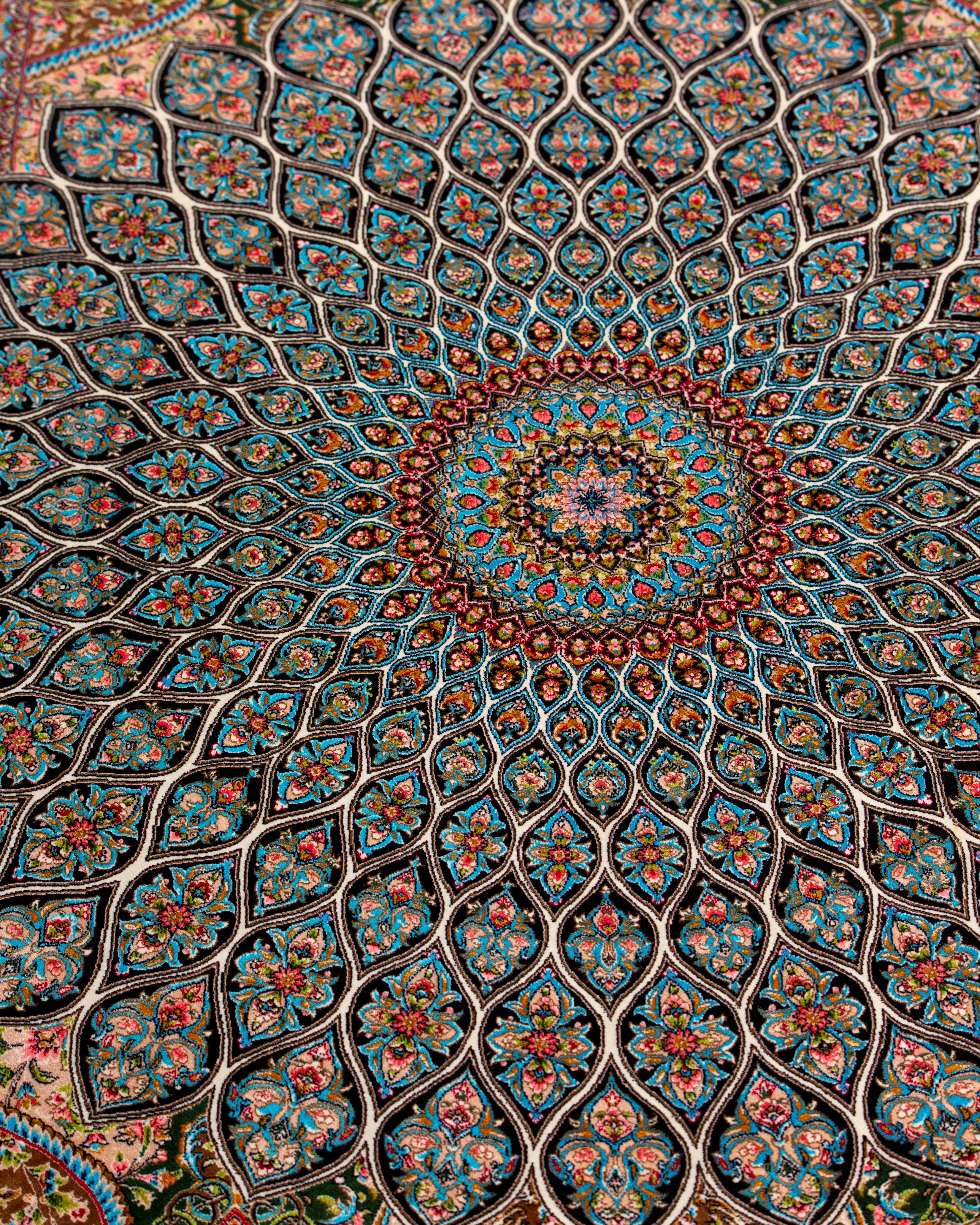 Radiating dome pattern detail of the Zumurrud green silk rug