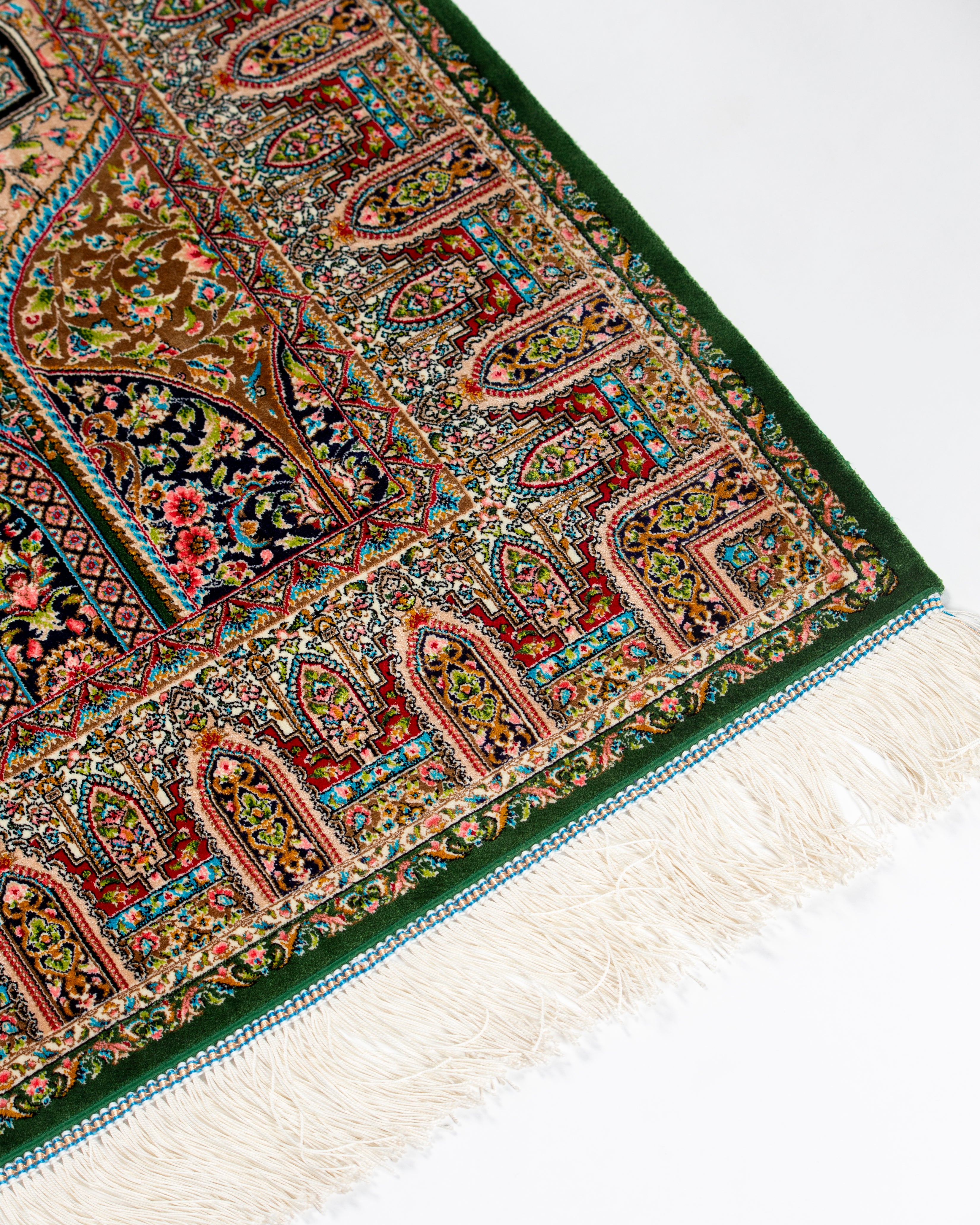 Floral lattice detail of the Zumurrud green silk rug